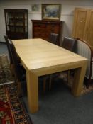 A contemporary light oak dining room table, length 200 cm,