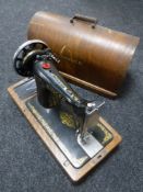 A mid 20th century oak cased Singer hand sewing machine