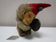 A wind up mechanical monkey with cymbals