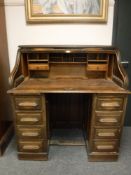 An Edwardian oak roll top desk,