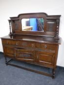 An early 20th century carved oak sideboard