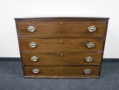 A George III inlaid mahogany four drawer chest with brass handles
