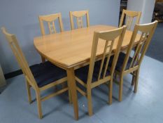 A pine extending kitchen table and six chairs