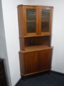 A mid 20th century teak corner display cabinet