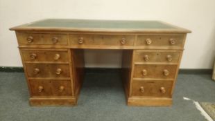 A late Victorian walnut twin pedestal writing desk, width 137 cm.