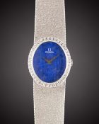 A LADIES 18K SOLID WHITE GOLD & DIAMOND OMEGA BRACELET WATCH CIRCA 1977, REF. 7-854 WITH LAPIS