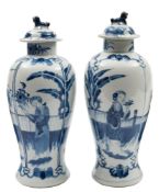 A pair of Chinese blue and white baluster vases and covers: with lion dog finials,