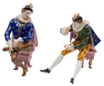 A pair of Continental porcelain figures: of 'Elizabethan' gentleman modelled seated on stools and