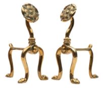 A pair of Art Nouveau brass fire dogs: on U-shaped front supports with Tudor rose terminals, 27cm.
