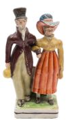 A Staffordshire pearlware group 'The Dandies': the fashionable lady holding a handbag,