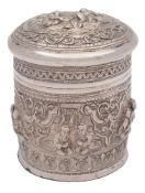 A Burmese silver jar and cover: the domed pull-off lid with embossed decoration of figures seated