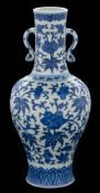 A Chinese blue and white vase: of baluster form with waisted slender neck and ruyi handles,