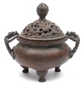 A Chinese bronze tripod 'dragon' censer and cover: of circular form with pierced cover and chilong