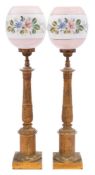 A pair of 19th century French gilt metal table lamps: on reeded and acanthus decorated columns,