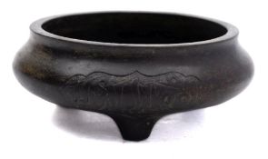 A small Chinese Islamic market bronze tripod censer: cast on each side with a panel of Islamic
