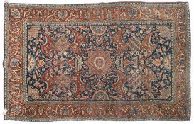 A Kashan rug:, the indigo field with a central geometric stellar medallion and all over palmette,