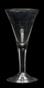 A large mid 18th century wine glass: with trumpet-shaped bowl, on air tear stem and folded foot, 26.