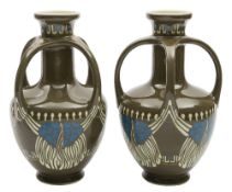 A pair of Villeroy & Boch Art Nouveau vases: each of oviform with raised neck supported by four