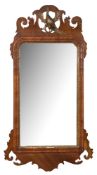A Georgian mahogany and partly gilt fret cut mirror:, with pierced Ho-ho bird cresting,