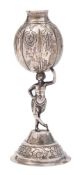 An Argentinean silver bombilla: the ovoid bowl supported on a semi-nude female figure standing on a