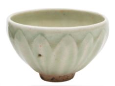 A small Chinese celadon bowl: the exterior moulded with lotus leaves, probably Song Dynasty,