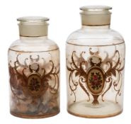 A pair of late 19th Century glass shop window jars and covers: each with gilt cartouches containing