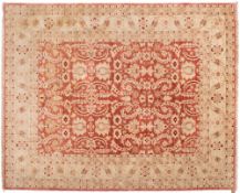 A contemporary Pakistan carpet:, the brick red field with all over geometric foliate design,