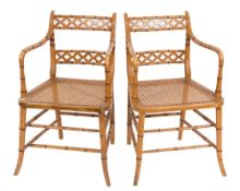A pair of painted beech and simulated bamboo elbow chairs in the Regency taste:,