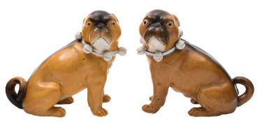 A pair of late 19th century Continental porcelain models of pug dogs: seated and wearing ribbon