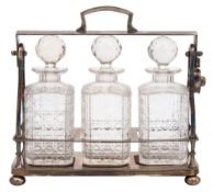 A silver plated tantalus: of arched outline,