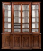 A Regency mahogany breakfront library bookcase:, the upper part with a moulded cornice,