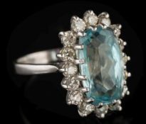 An aquamarine and diamond oval cluster ring: the oval aquamarine approximately 15mm wide x 9mm wide