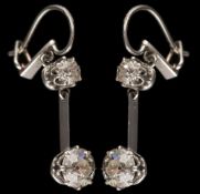 A pair of diamond two-stone drop earrings: each with a round old,