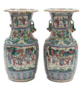 A pair of Canton famille rose baluster vases: the shoulders applied with lion dogs and chilong,