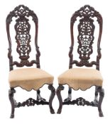 A pair of early 18th Century Indo Portuguese carved hardwood dining chairs:,