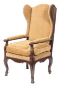 An 18th Century French Provincial oak wing armchair:, with upholstered back,