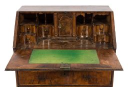 An early 18th Century walnut veneered and cross and feather banded bureau:,