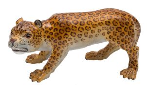 A Meissen porcelain figure of a leopard: naturalistically modelled and painted,