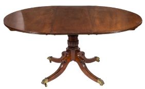 A mahogany circular extending dining table in the Regency taste:,