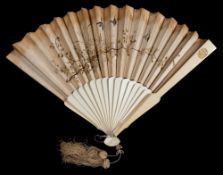 An Edwardian Japanese fan: the silk leaf embroidered with butterflies and insects amongst flowering