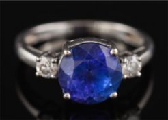 A modern tanzanite and diamond ring: the round tanzanite approximately 8.7mm diameter x 6.