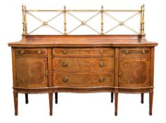An Edwardian mahogany and inlaid sideboard:, of serpentine fronted outline,