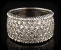 An 18ct white gold and diamond band cluster ring: with a 10mm wide band,
