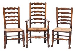 A harlequin set of eight early 19th Century elm and ash 'Wavy' ladderback dining chairs:,