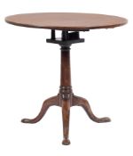 A mid 18th Century mahogany circular tea table:, the snap top on turned central column,