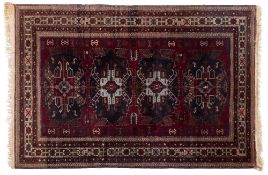 A Derbend rug:, the purple field with four indigo and powder blue geometric medallions,