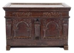 A 17th Century Continental oak coffer:, of small size, with a plain hinged moulded top,