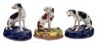 A pair of English porcelain models of hounds and one other: the pair with black markings,