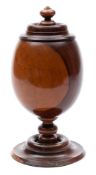A 19th century turned lignum vitae cup and cover: of ovoid form, on knopped stem and circular base,
