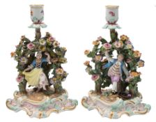 A pair of Meissen figural candlesticks modelled after Ernst Leuteritz: in the form of a youth and a